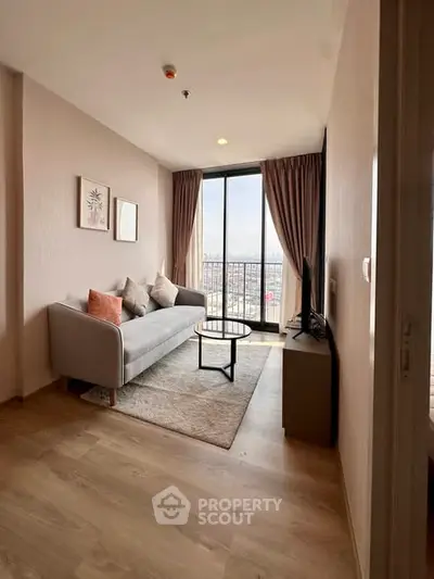 Modern living room with cozy sofa and city view from large window.
