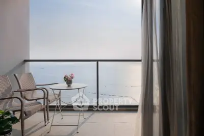 Stunning ocean view from a modern balcony with elegant seating and decor.
