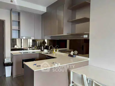 Modern kitchen with sleek cabinetry and integrated appliances in a stylish apartment.
