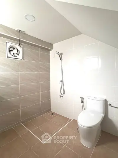 Modern bathroom with sleek tiles and efficient shower design