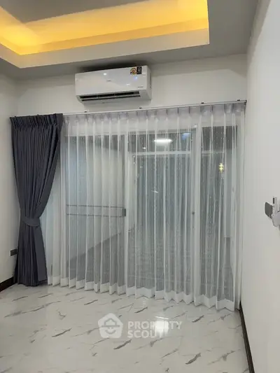 Modern living room with elegant curtains and air conditioning unit