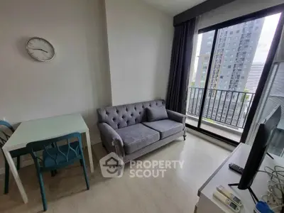 Modern living room with elegant sofa and city view balcony in high-rise apartment