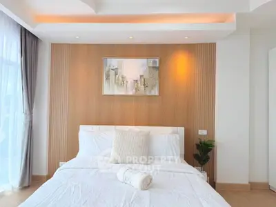 Modern bedroom with elegant decor and natural light, featuring a stylish wooden accent wall and cozy bedding.