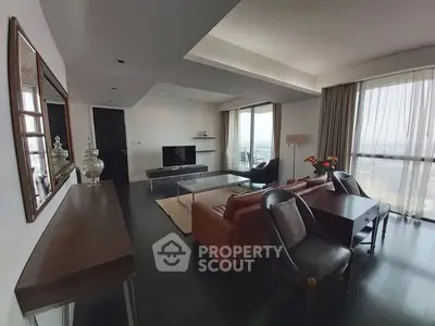 Spacious modern living room with large windows and elegant decor