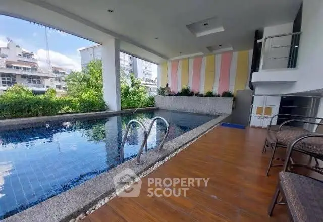 Stylish covered pool area with modern design and city views