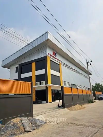 Modern industrial building with sleek design and ample parking space