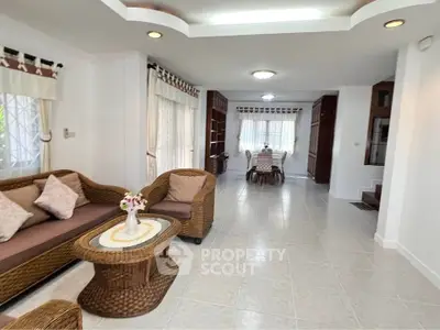 Spacious living room with wicker furniture and elegant dining area