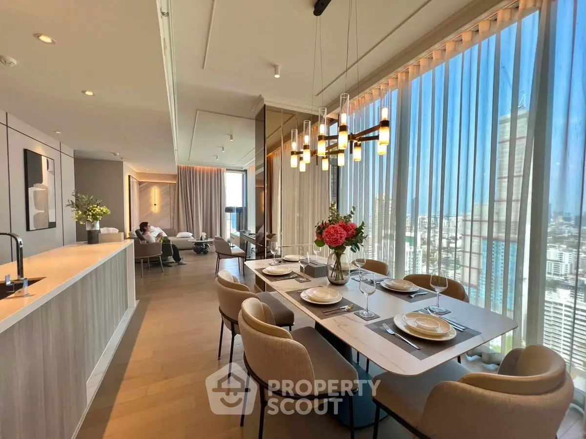 Luxurious open-plan living and dining area with panoramic city views and elegant decor.