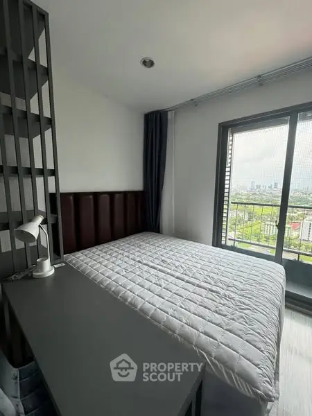 Modern bedroom with city view and sleek furnishings