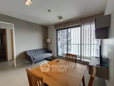 Modern living room with sleek furniture and large windows in a contemporary apartment.