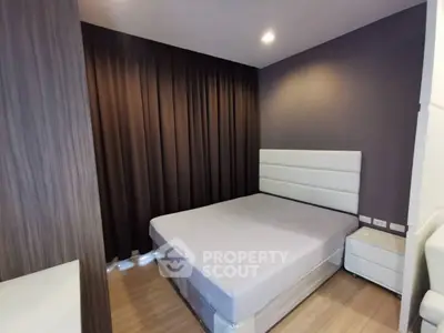 Modern bedroom with sleek design and cozy ambiance, featuring a comfortable bed and stylish decor.