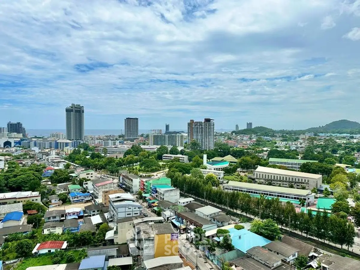 Stunning cityscape view from high-rise building showcasing urban landscape and greenery.