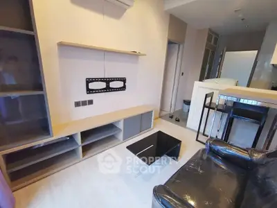 Modern living room with sleek furniture and wall-mounted TV setup in a stylish apartment.