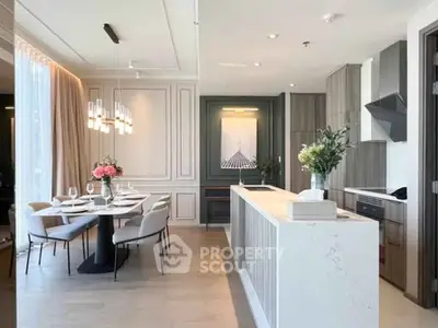 Elegant open-layout kitchen and dining area with modern decor and stylish lighting.