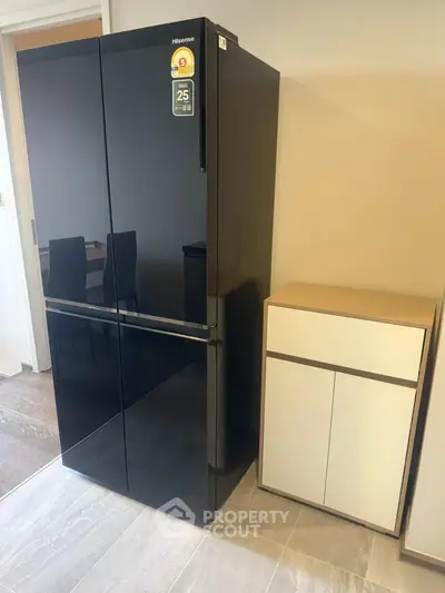 Modern kitchen with sleek black refrigerator and stylish storage cabinet