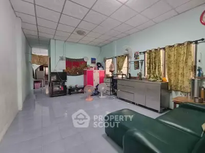Spacious living room with tiled floor, ceiling fans, and cozy seating area.
