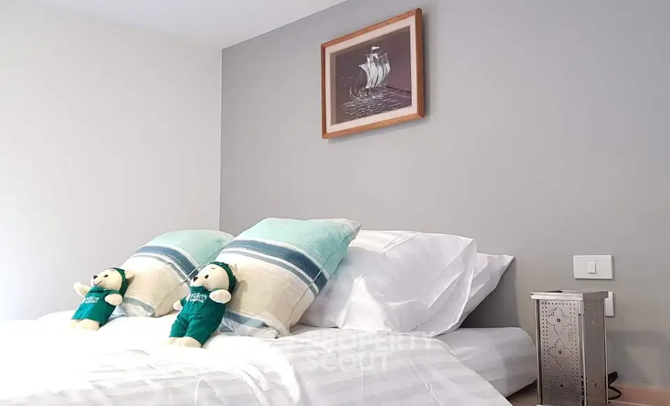 Cozy bedroom with stylish decor and plush bedding, perfect for relaxation.