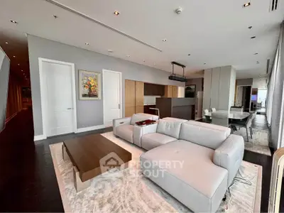 Luxurious modern living room with sleek furniture and open kitchen layout in high-end apartment.