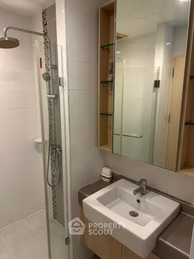 Modern bathroom with sleek shower and stylish sink in contemporary design.