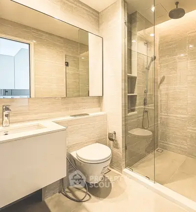 Modern bathroom with glass shower and sleek vanity in luxury apartment.