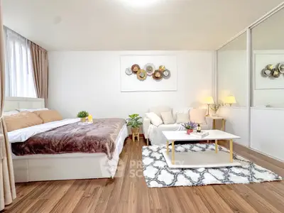 Spacious bedroom with cozy seating area and modern decor