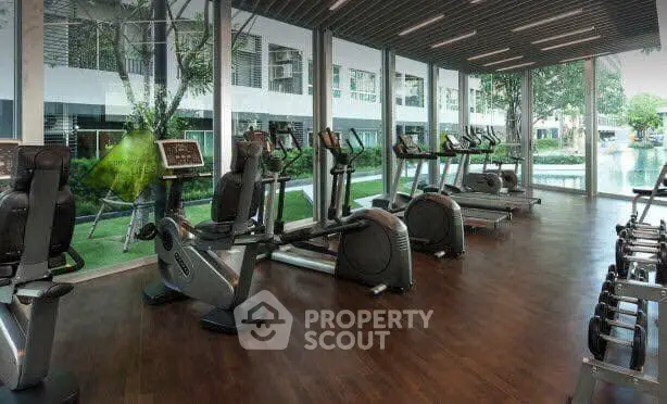 Modern gym with state-of-the-art equipment and scenic outdoor view.