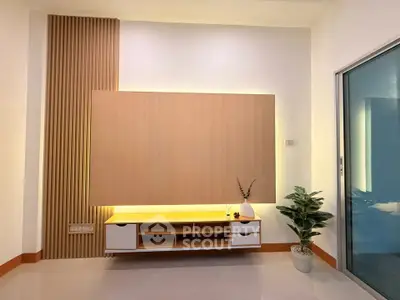 Modern living room with stylish wooden paneling and ambient lighting
