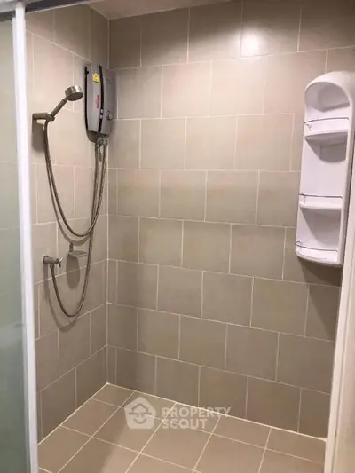 Modern bathroom with sleek shower and tiled walls in a contemporary home.