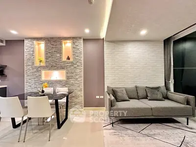 Modern living room with stylish decor and dining area, featuring a cozy gray sofa and elegant dining set.