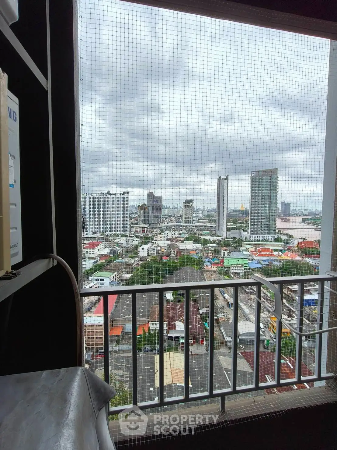 Stunning cityscape view from a modern balcony with unique architectural design.