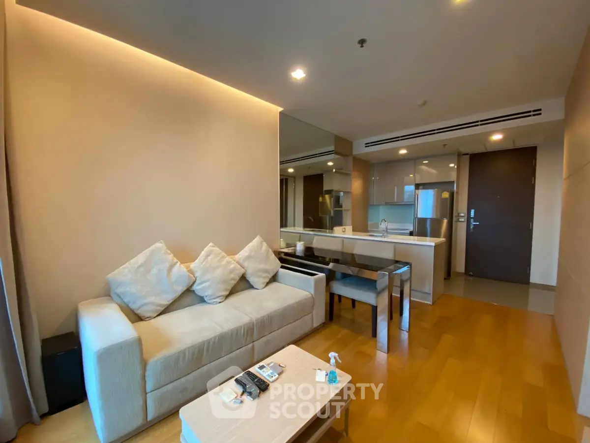 Modern living room with open kitchen layout and cozy seating area