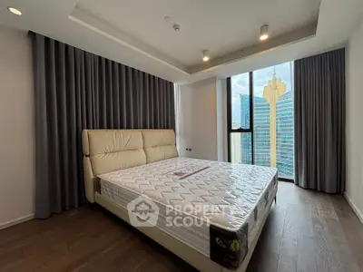 Luxurious bedroom with city view in modern high-rise apartment