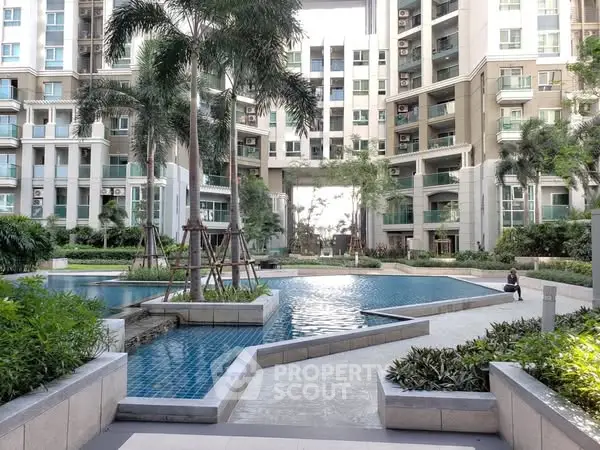 Luxurious residential complex with stunning pool and lush greenery