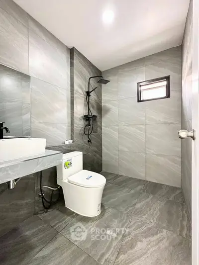 Modern bathroom with sleek gray tiles and contemporary fixtures