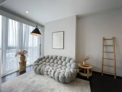 Modern living room with stylish sofa and floor-to-ceiling windows