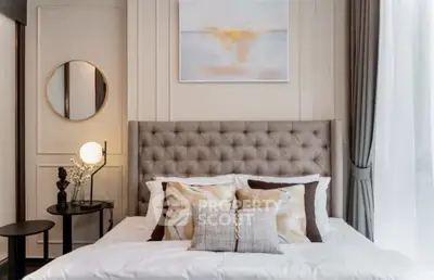 Luxurious bedroom with elegant decor and plush bedding in modern apartment.
