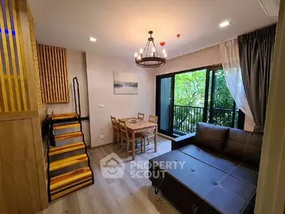 Charming living room with modern decor and balcony view, perfect for relaxation and entertaining.