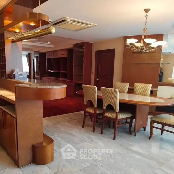 Luxurious open-plan living and dining area with elegant furnishings and modern lighting.