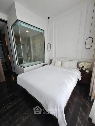 Modern bedroom with glass-enclosed shower and elegant decor