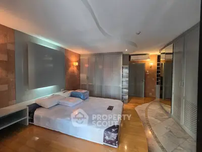 Spacious modern bedroom with stylish decor and ample storage space