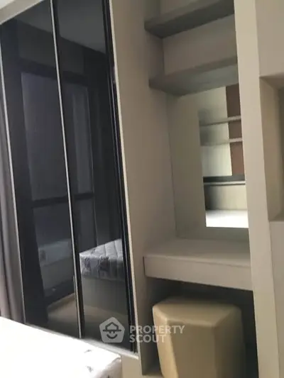 Modern bedroom with sleek built-in wardrobe and cozy seating area