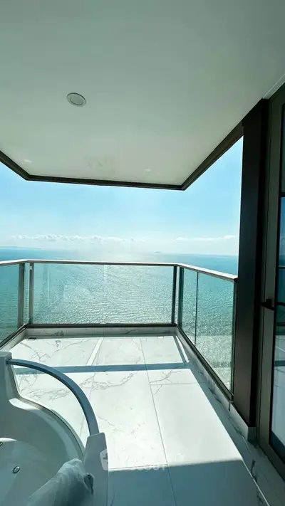 Luxurious balcony with stunning ocean view and modern glass railing