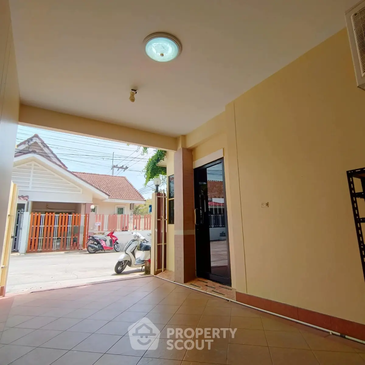 Charming entrance with tiled flooring and street view, perfect for welcoming guests.