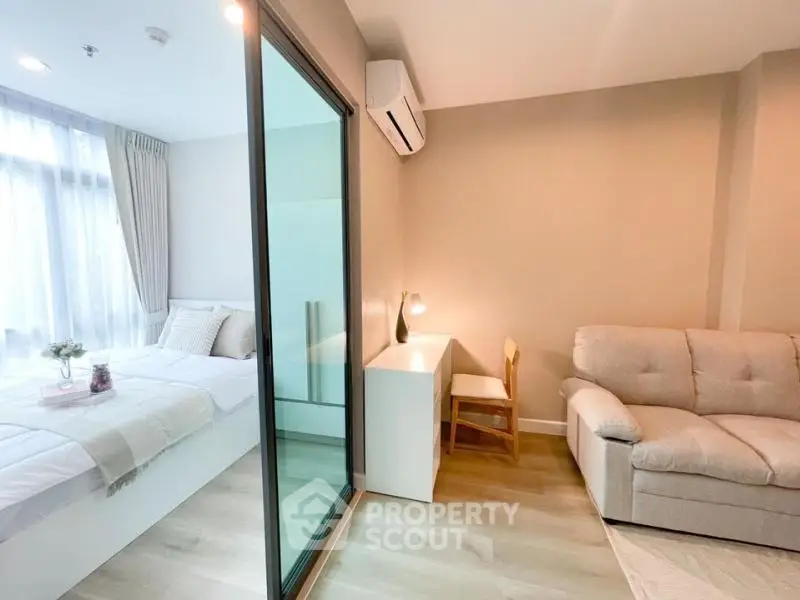 Modern studio apartment with cozy bedroom and living area, featuring stylish decor and natural light.