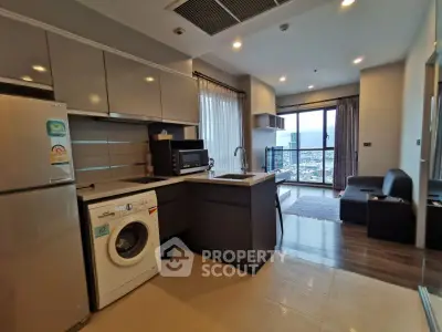 Modern kitchen with washing machine and open layout in high-rise apartment