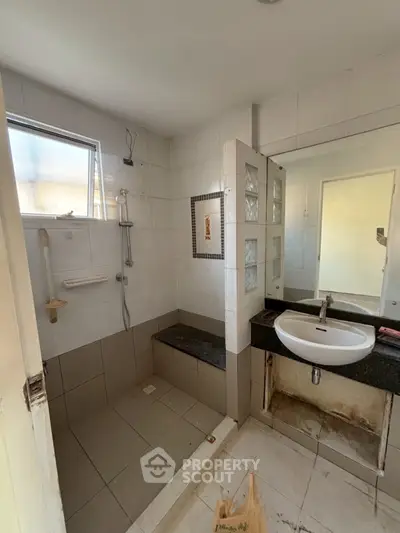 Spacious bathroom with modern shower and sleek sink design