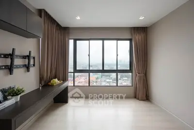 Spacious living room with large windows offering a stunning city view, perfect for modern urban living.