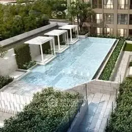 Luxurious rooftop pool with modern cabanas and lush greenery