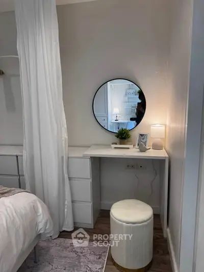 Cozy bedroom corner with vanity, mirror, and soft lighting.