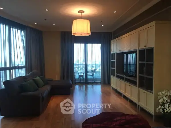 Spacious living room with large windows and elegant decor